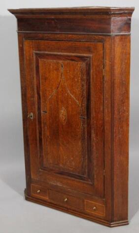 An 18thC oak hanging corner cupboard