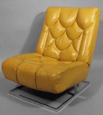 A mustard leather and chrome framed retro low open chair