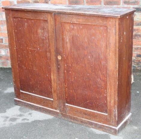 A late 19thC oak and stained pine cupboard