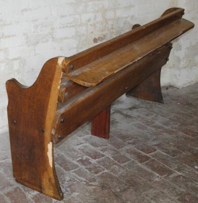 A stained oak slat back church pew - 2