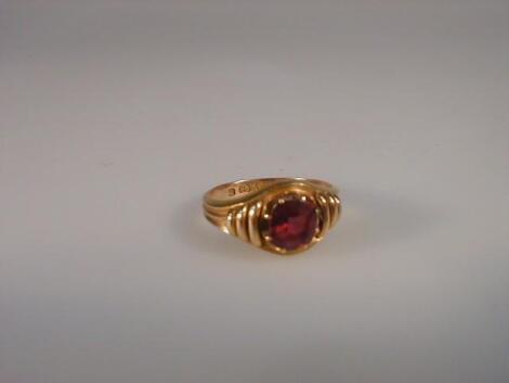 A gentleman's garnet set signet ring in 15ct yellow gold