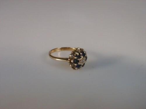A diamond and sapphire cluster ring set in 9ct yellow gold