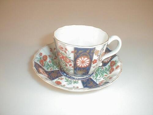 A First period Worcester cup and saucer of fluted form painted in colours