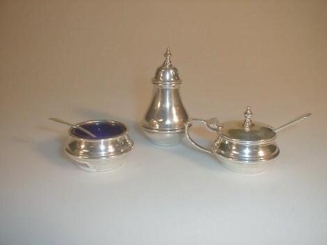 A George V silver three piece cruet set of baluster form with an annulated girdle