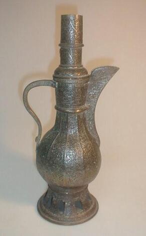 A middle Eastern ornate tin and copper ewer