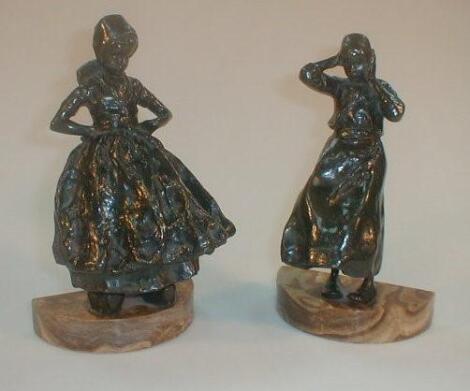 A pair of Art Deco bronze figures of young ladies in Dutch costume