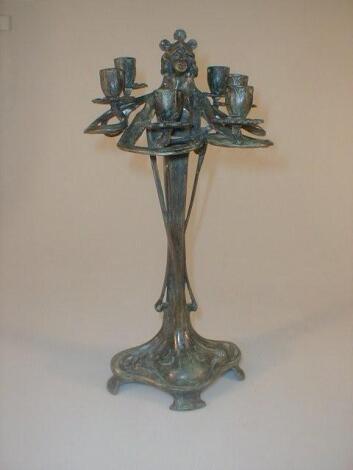 An Art Nouveau style green patinated bronze candelabrum