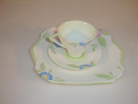 A Shelley china Vogue cup and saucer and matching large plate painted with