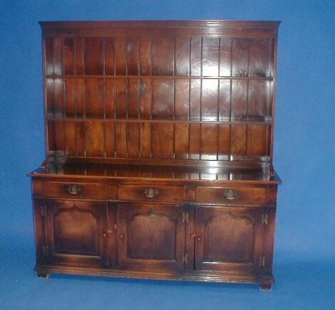 A quality reproduction oak dresser with plate rack