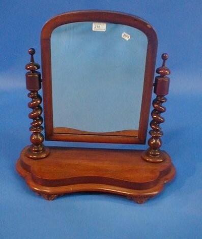 A Victorian mahogany dressing table mirror with barley twist supports and shaped base