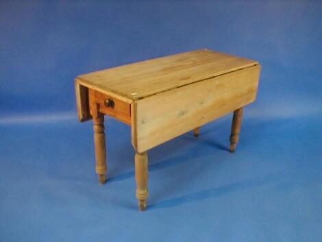 A Victorian stripped pine Pembroke kitchen table with scrub top