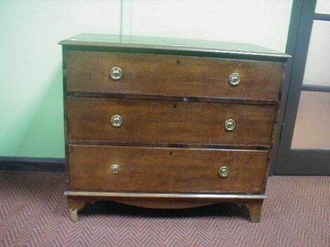 A Georgian oak three drawer chest with brass ring handles