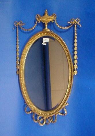 An Edwardian oval wall mirror with gilt neo-classical framework