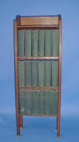 An oak open bookcase complete with the Charles Dickens library