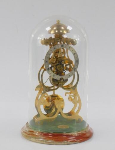 A Thwaites & Reed brass skelton clock