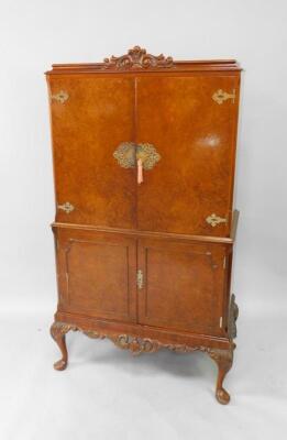 A mid 20thC burr walnut cocktail cabinet