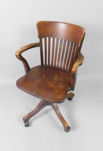 A Victorian oak lath back swivel office chair.