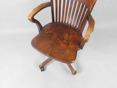 A Victorian oak lath back swivel office chair. - 2