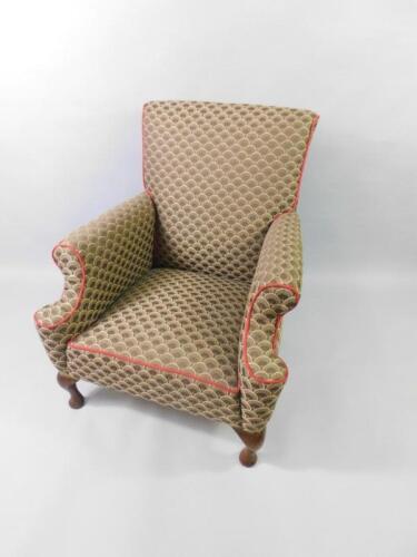 An Edwardian mahogany armchair upholstered in brown scale fabric