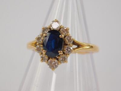 A sapphire and diamond oval ring