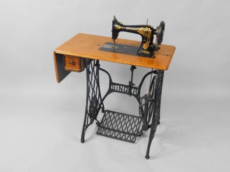 A Singer treadle sewing machine on an iron base