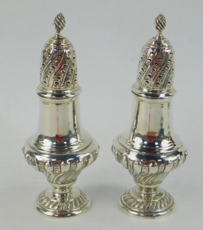 A pair of Victorian silver semi fluted baluster sugar sifters