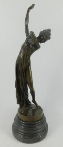 A bronze figure of a semi draped classical woman