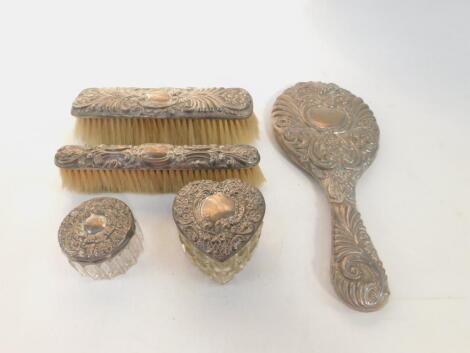 A Victorian silver backed three piece dressing table set