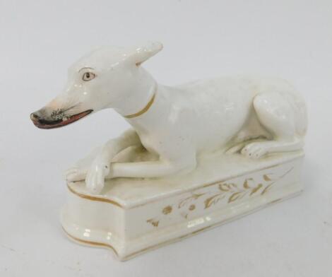 A Staffordshire early 19thC porcelain figure of a recumbent greyhound