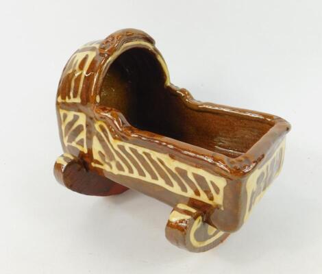 An 18thC style slipware cradle