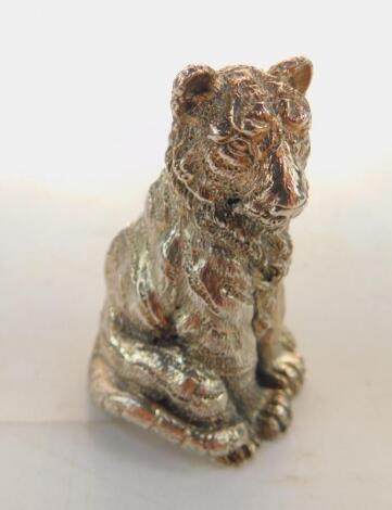 A silver figure modelled as a seated tiger