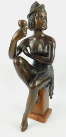 A bronze figure of a semi clad woman