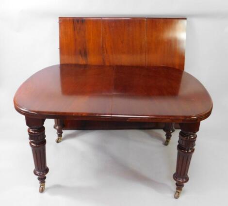 A Victorian mahogany oval wind out dining table