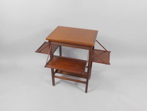 An Edwardian mahogany fold over bridge table