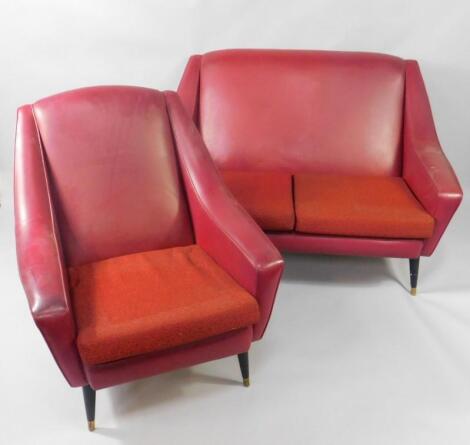 A 1950's red vinyl atomic two seater sofa