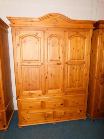 A pine three door wardrobe