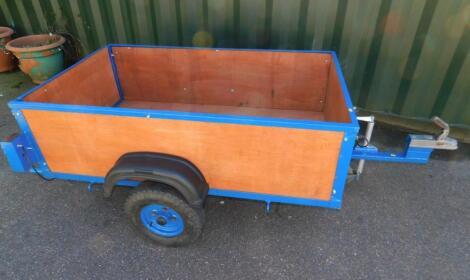 A wooden and metal bound car trailer