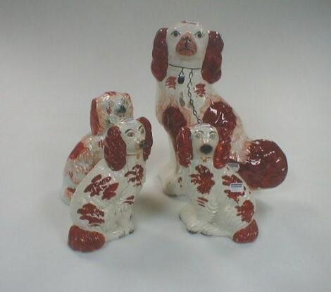 A pair and two other Victorian Staffordshire Spaniels with liver splash decoration