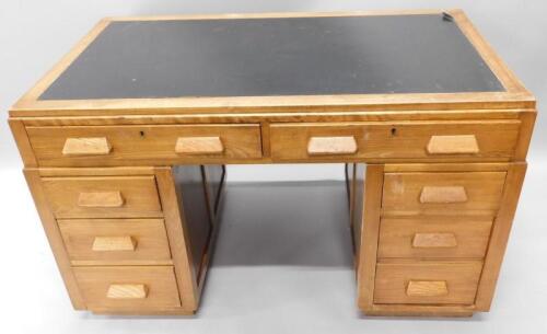 An early to mid 20thC beech and ash kneehole desk