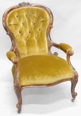 A Victorian walnut show frame open armchair