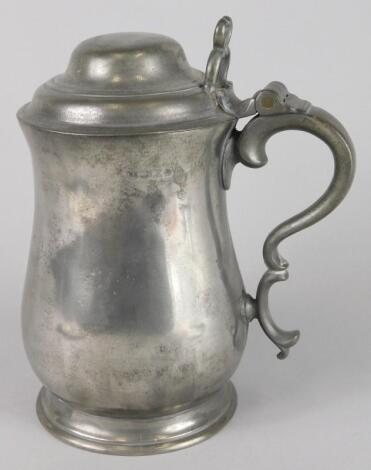 An early 19thC pewter baluster shaped lidded flagon