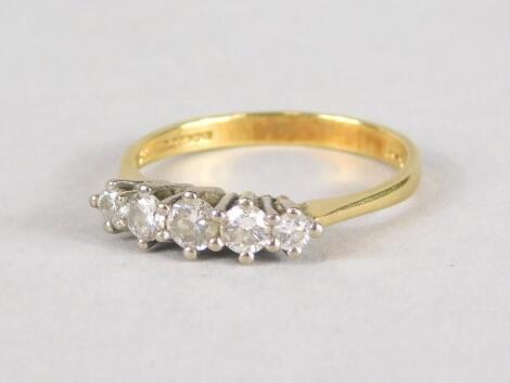 An 18ct gold five stone diamond dress ring