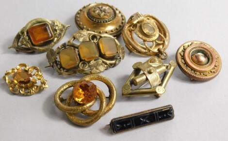 Nine gilt metal brooches