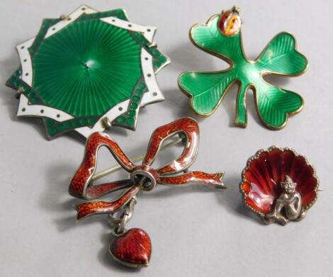 Four silver and enamel set brooches