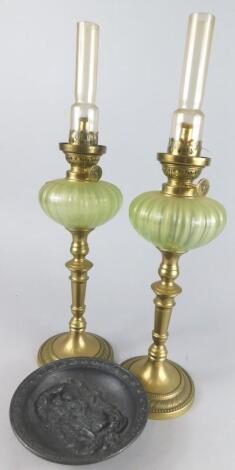 A pair of early 20thC brass and glass candlestick lamps