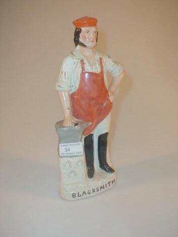 A 19thC Staffordshire Pottery figure of a blacksmith