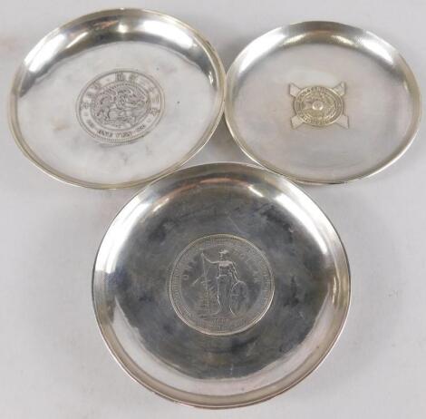 Three various Chinese white coloured metal dishes