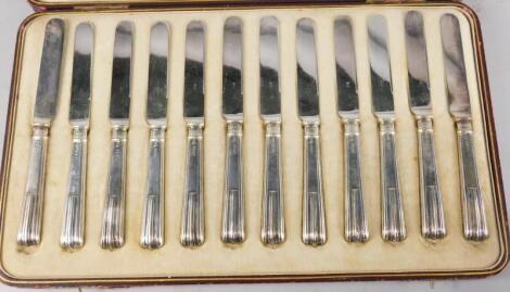 A Hamilton & Inches cased set of twelve George V silver butter knives