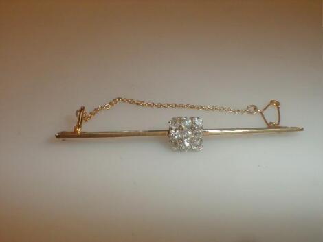 A bar brooch set with a small square of nine tiny diamonds