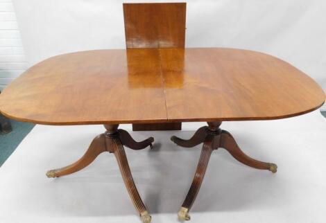 A mahogany extending two pillar dining table